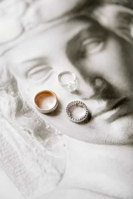 Wedding rings styled on sculpted stone surface during details shoot at Castello di Velona.
