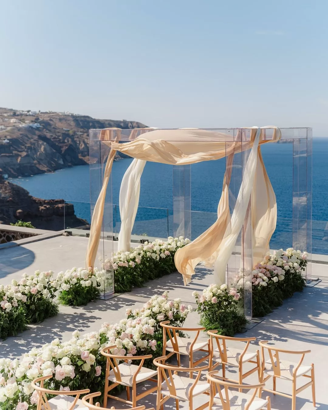 Romantic floral arch at Cavo Ventus, framing the couple’s ceremony with breathtaking ocean views.