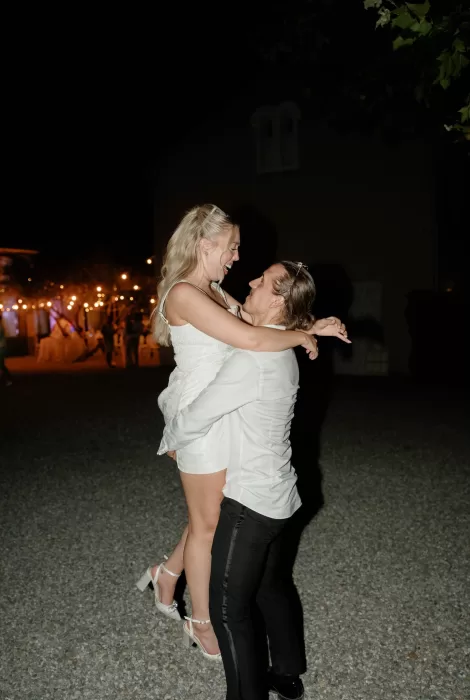 Bride and groom dancing under warm string lights at Château Canet, celebrating late into the evening in the gravel courtyard.