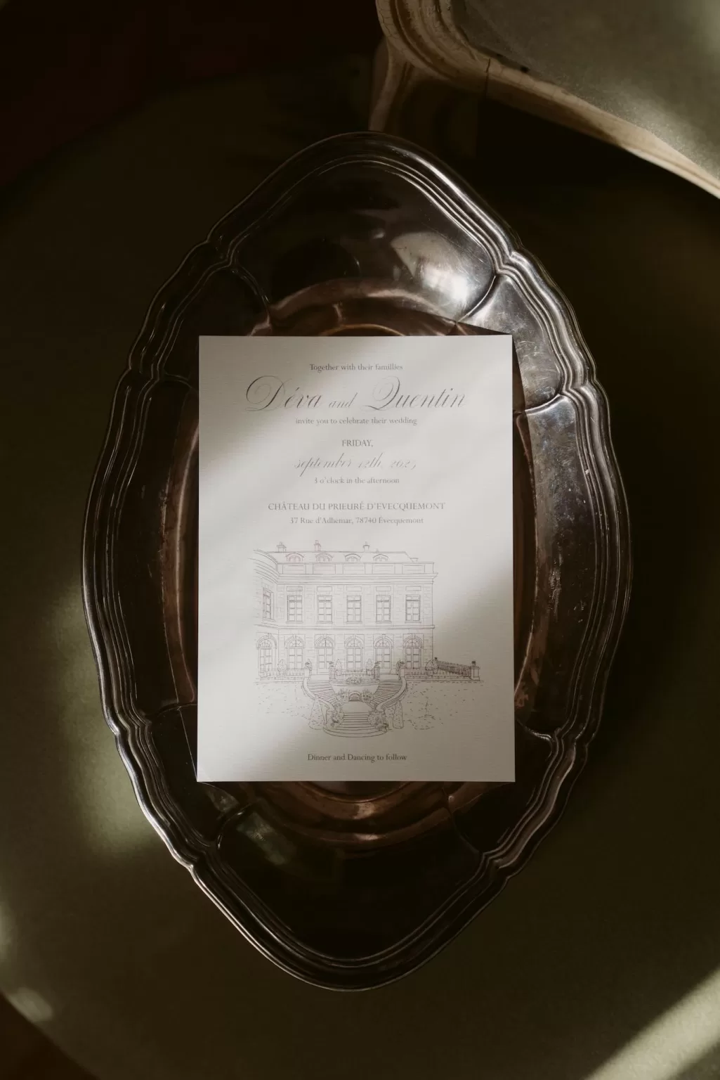 Elegant wedding invitation displayed on a silver tray at Château du Prieuré d’Evecquemont, styled in soft natural light.