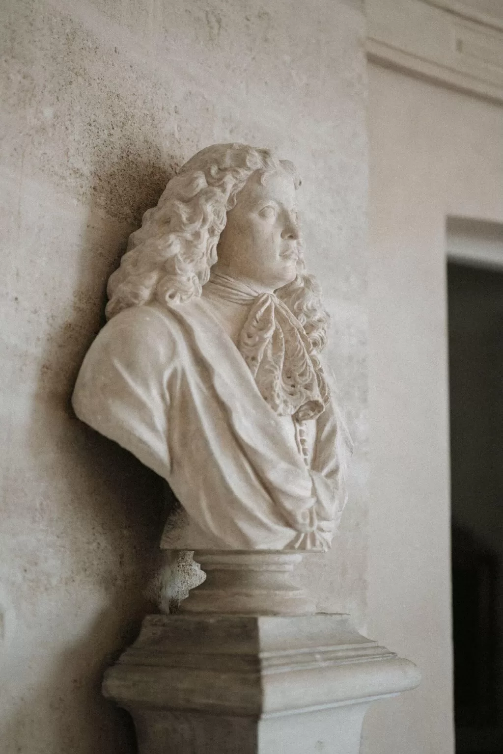 Elegant marble bust inside Château de Villette, showcasing classical French artistry and timeless architecture.