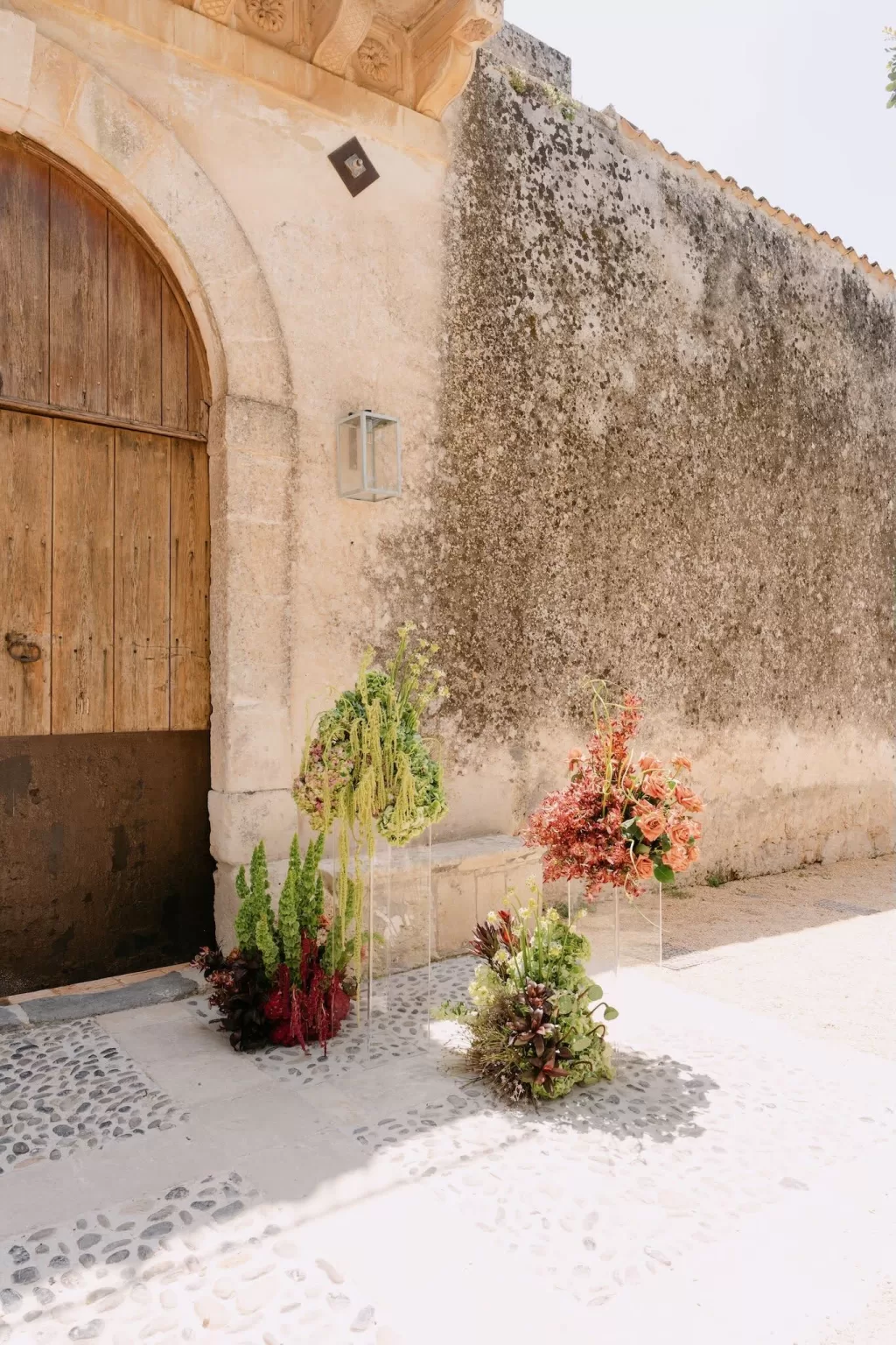 Lush floral arrangements in warm tones decorating the ceremony space at Dimora Delle Balze.