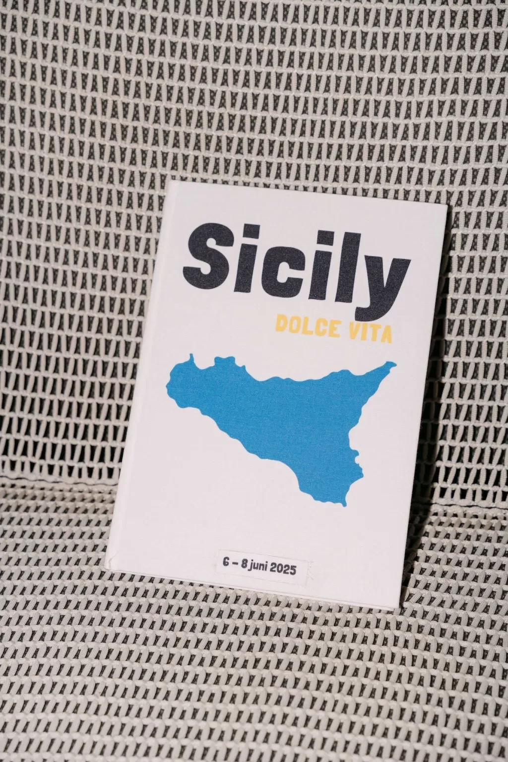 Modern wedding invitation with blue Sicily map and “Dolce Vita” text photographed at Dimora Delle Balze.