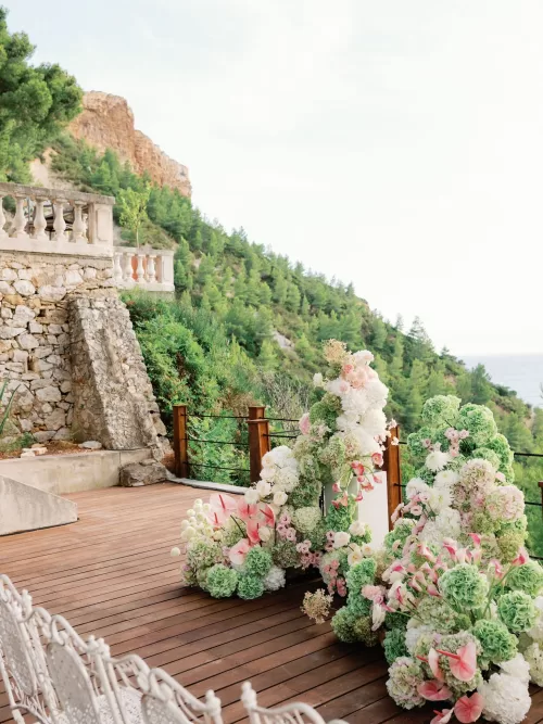 Wooden ceremony deck at Domaine de Canaille styled with floral installations and coastal views.