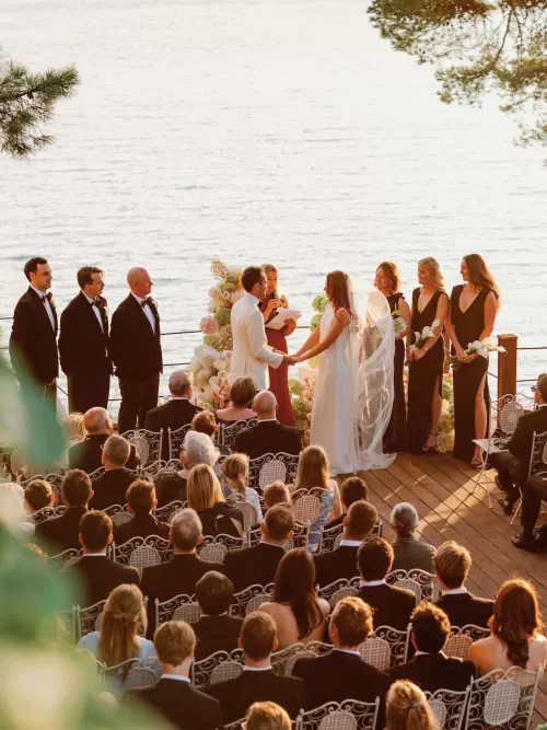 Outdoor wedding ceremony with guests seated on a terrace overlooking the sea at Domaine de Canaille