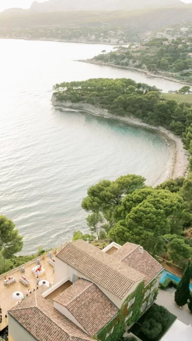 Aerial view of Domaine de Canaille perched above a secluded Mediterranean cove and pine-covered coastline