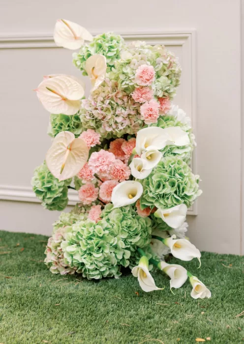 Sculptural floral installation with soft green and blush tones at Domaine de Canaille wedding decor