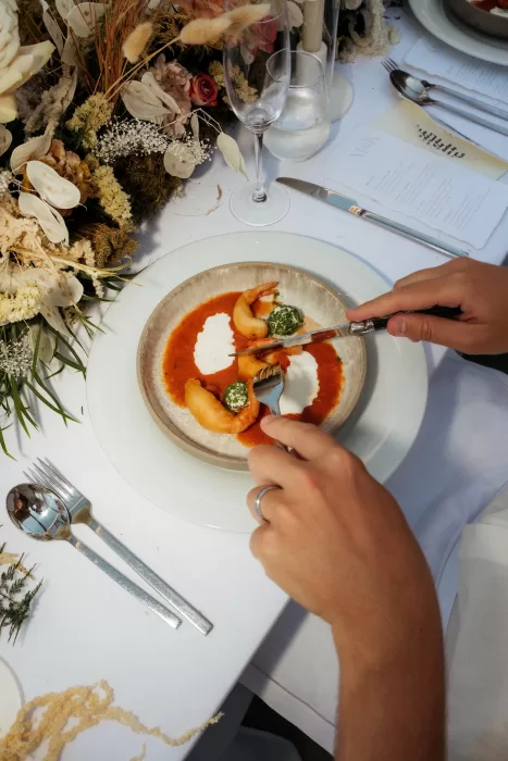 Elegant plated seafood course served at Milos Cove wedding reception table with floral styling.