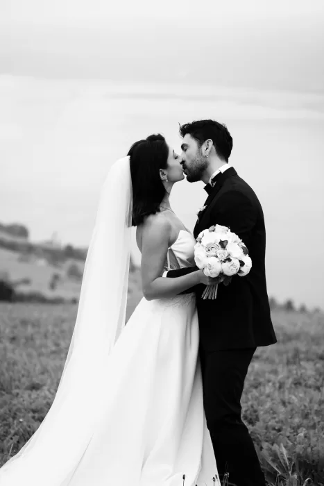 Bride and groom embracing on a hillside above Lake Lucerne during their Villa Honegg destination wedding.