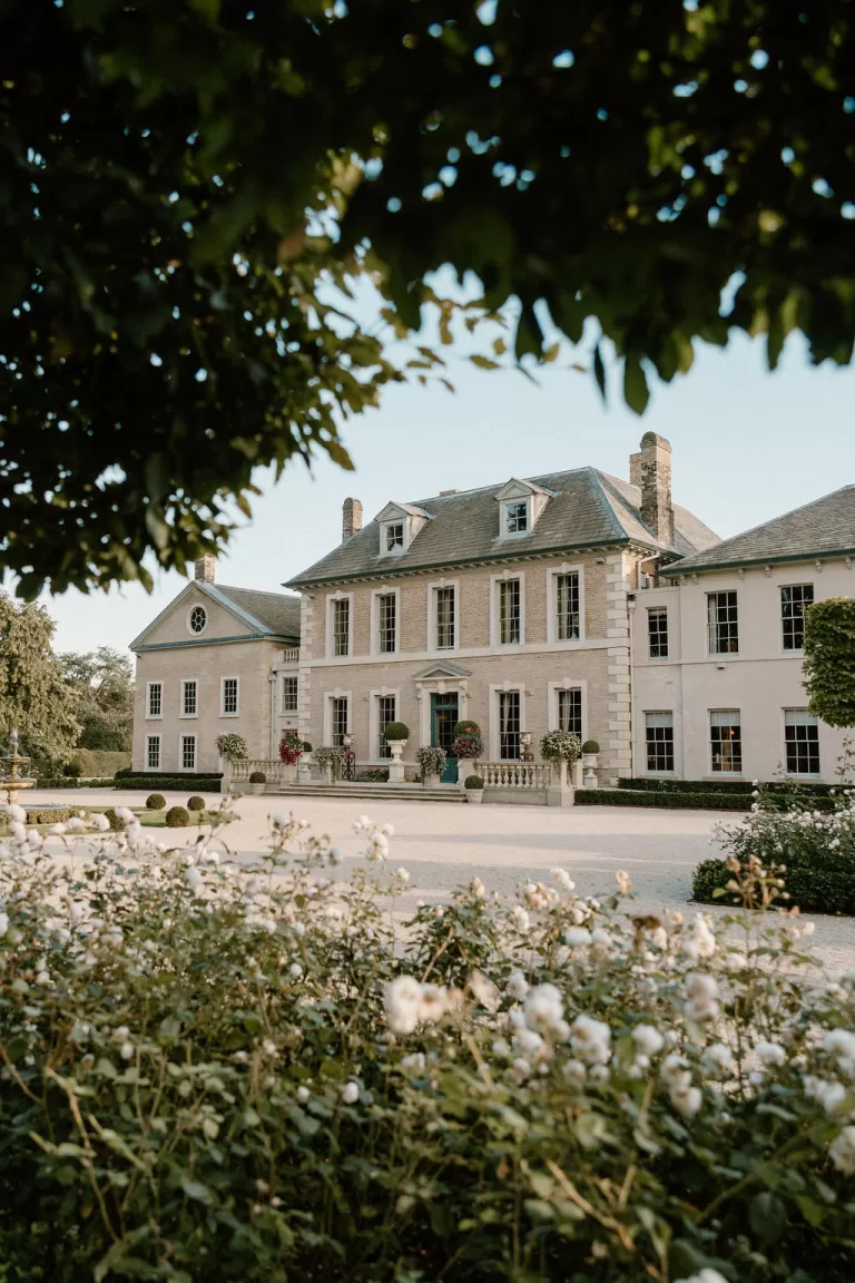 Hotham Hall Estate framed by blooming rose garden and soft greenery