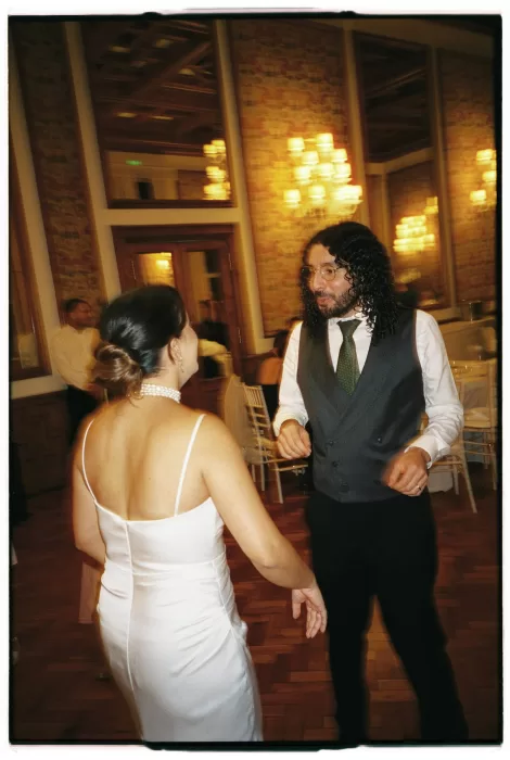 Bride and groom dancing together during the evening reception inside the elegant Infante Sagres ballroom.