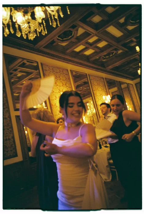 Bride dancing with guests under chandeliers during the lively reception at Infante Sagres.