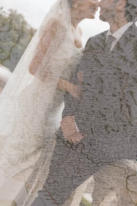 Artistic double exposure of couple kissing over vintage map evoking Isola del Garda destination setting