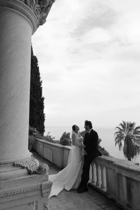 Black and white portrait of couple embracing on terrace overlooking Lake Garda at Isola del Garda