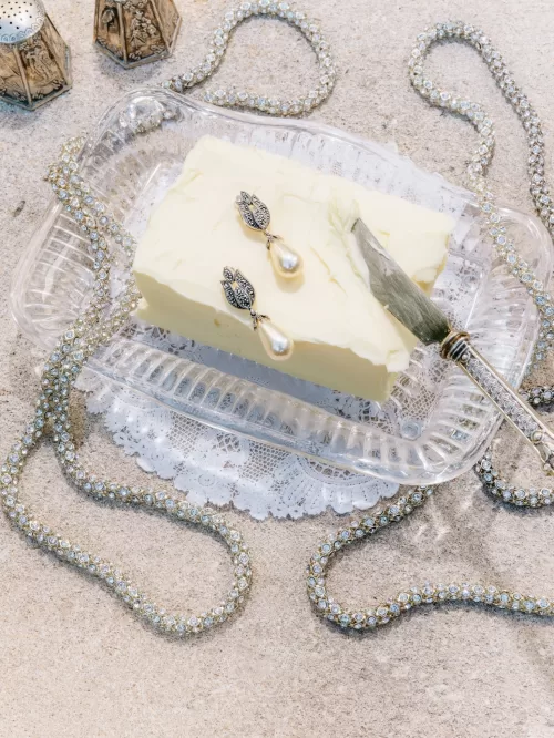 Vintage pearl drop earrings styled on butter dish with crystal tray and jeweled necklace at Mas de Chabran.