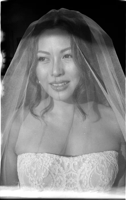 Black and white portrait of bride under veil with soft expression at Son Marroig