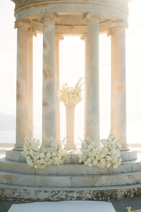 Close view of floral arrangements surrounding the ceremony altar at Son Marroig temple