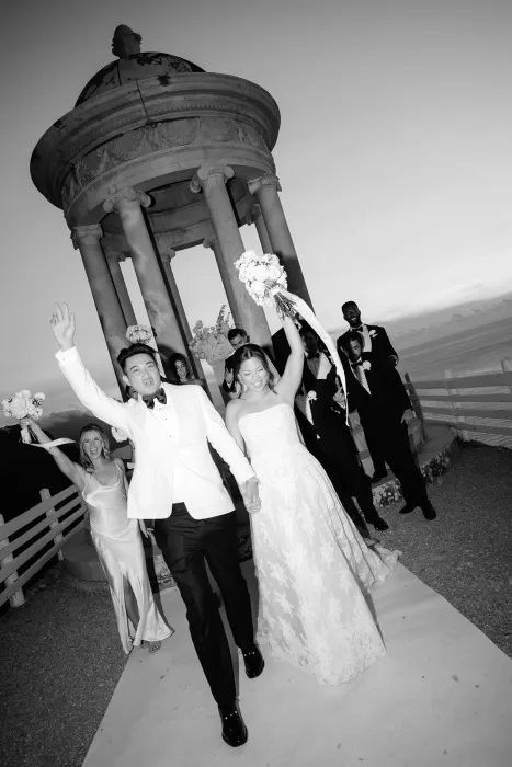 Bride and groom celebrating down the aisle at Son Marroig with joyful wedding party behind