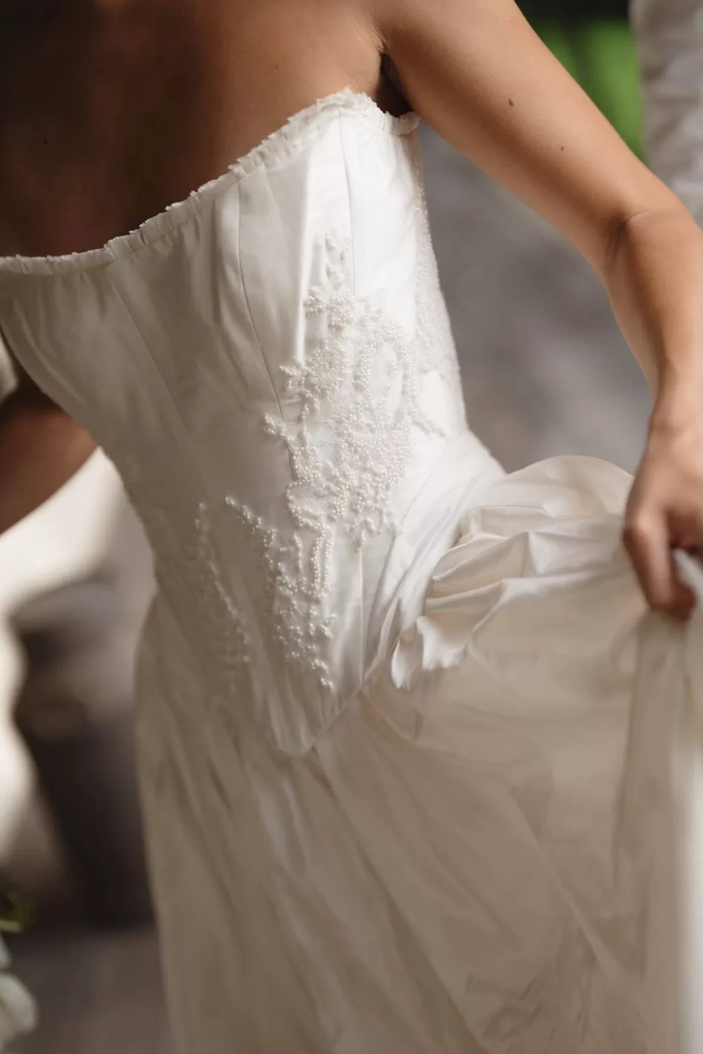 Close-up of strapless bridal gown with delicate embroidered beading at Wallalong House.
