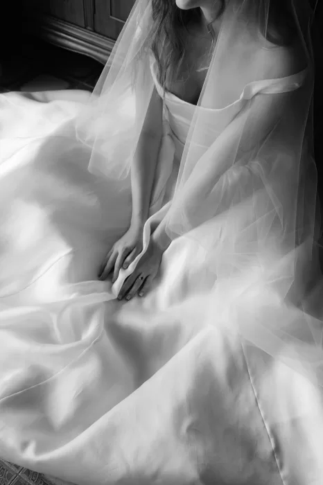 Close-up of silk wedding dress bodice with off-shoulder neckline at Finca Morneta
