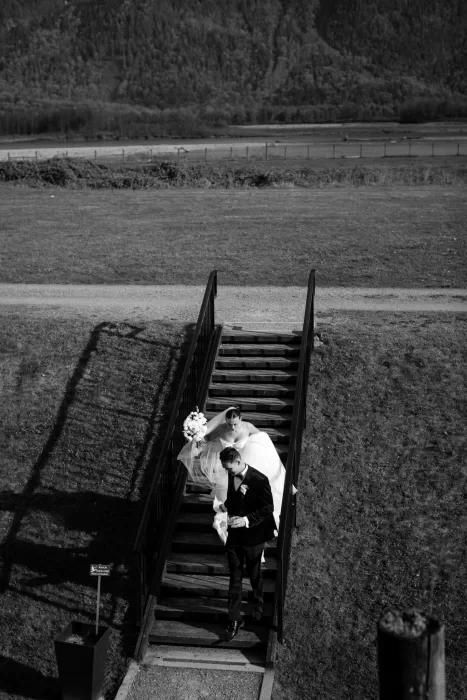 Black and white photo of couple walking down stairs at Fraser River Lodge