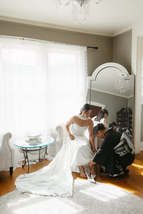 Bridal portrait in the grasslands at The Manor House, with a modern gown and dramatic veil.