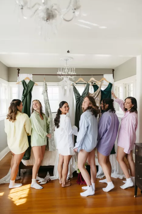 Bride and bridesmaids getting ready together in a sunlit room at The Manor House in Colorado.