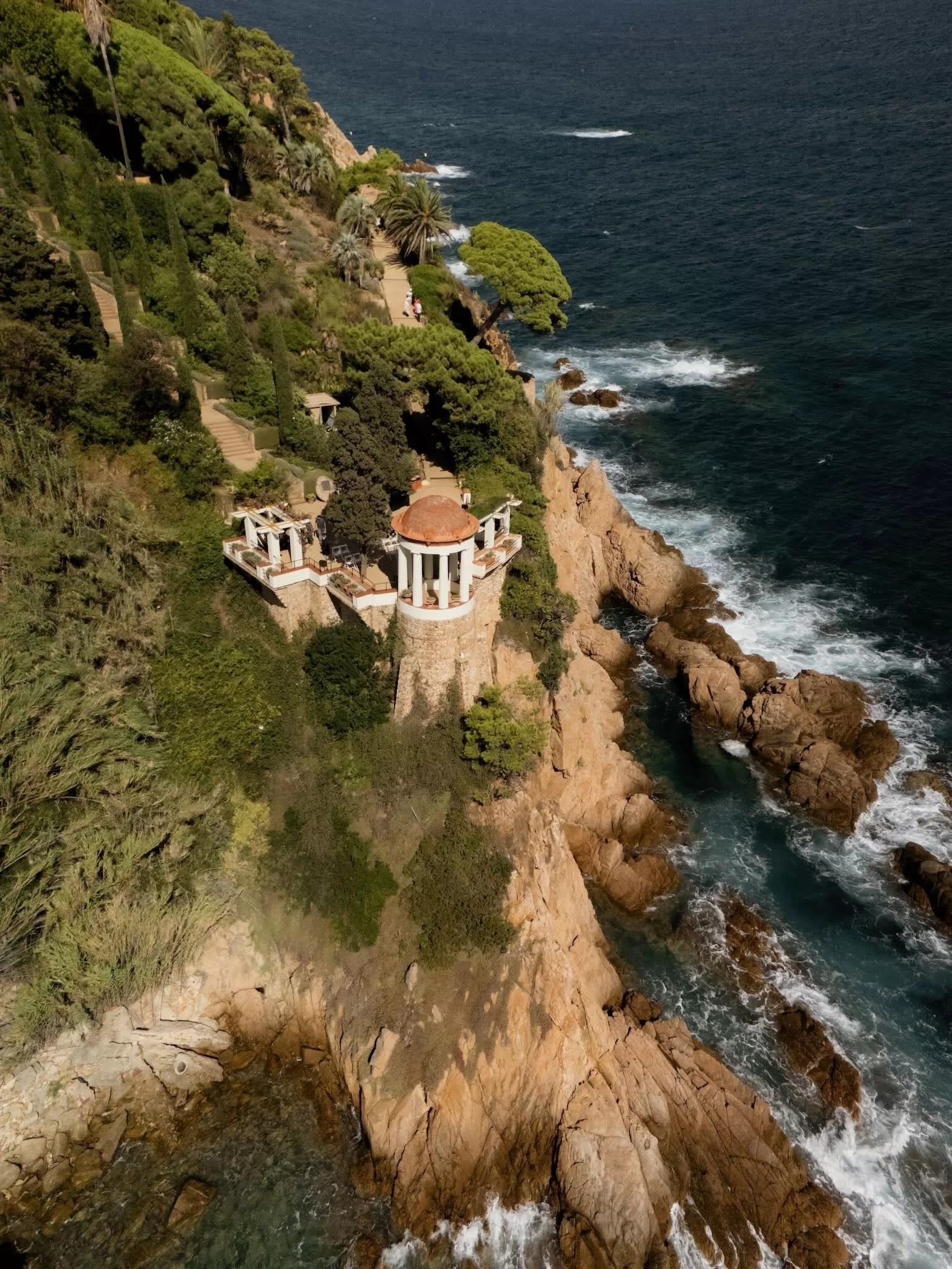 Aerial view of Marimurtra Botanical Garden perched on the cliffside overlooking the Mediterranean Sea.