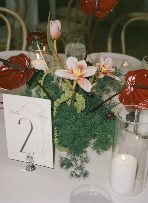 Reception table number with candlelight and floral centrepiece at Monserate Winery
