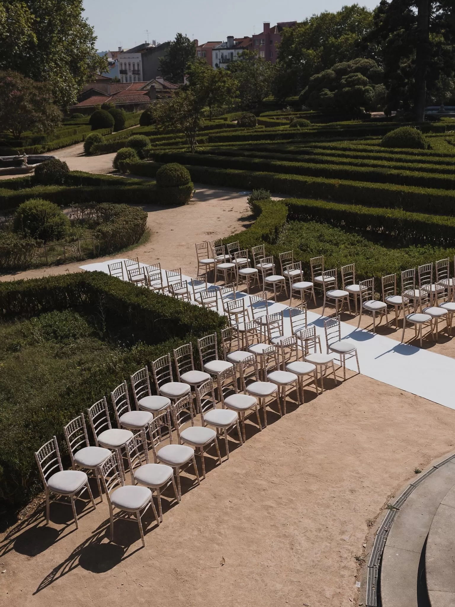 Aerial view of outdoor wedding ceremony setup surrounded by manicured gardens at Vandelli Botanical Garden.