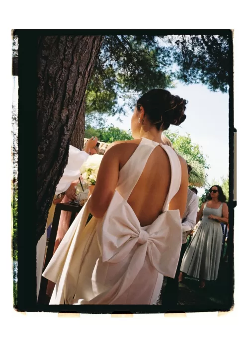 Back view of bride’s dress with oversized bow, capturing movement and modern silhouette