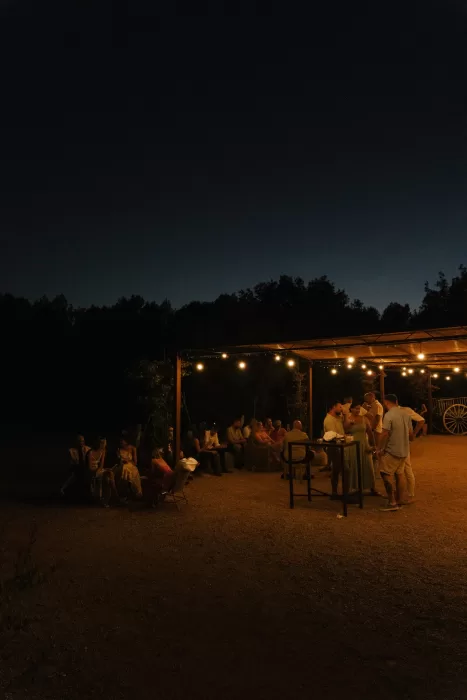 Guests gathered under warm string lights during an evening wedding reception at a Mallorca finca