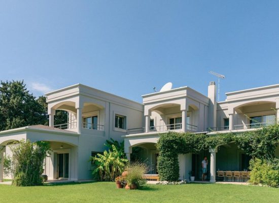 Entrance to Bello Blu in Greece, surrounded by beautifully landscaped gardens and Mediterranean greenery.