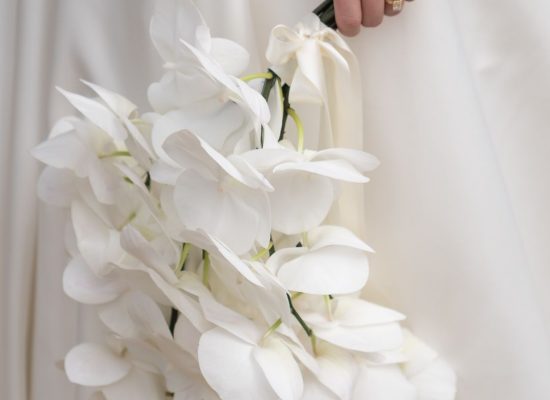 A close-up of a lush bridal bouquet filled with soft pastel blooms, captured by Bella Weddings.