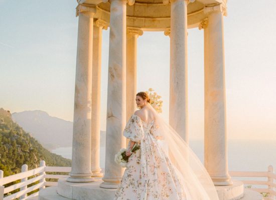 Bride posing gracefully during sunset, with warm golden light casting a beautiful glow on her.