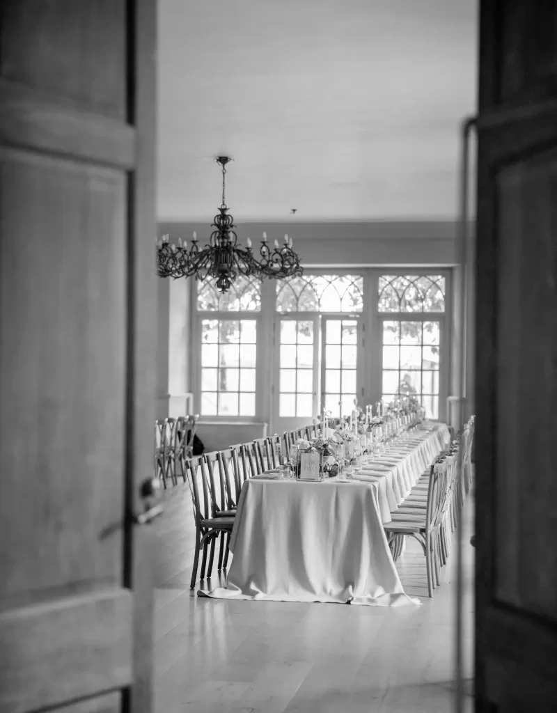 The couple shares a quiet embrace on a velvet settee in Euridge Manor’s stone corridor, away from the celebration.