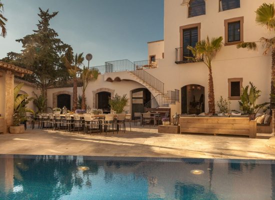 The rustic stone facade of Masia Victoria, showcasing its historic charm and Mediterranean architecture.